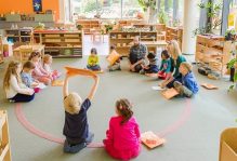 toddlers playing in classroom with teacher