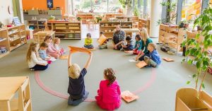 toddlers playing in classroom with teacher