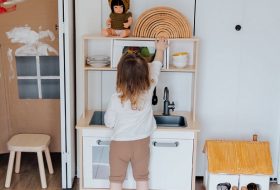 picture of a kid playing indoors with a kitchen build for kids