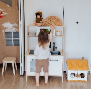 picture of a kid playing indoors with a kitchen build for kids