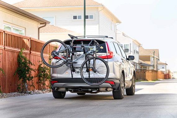 car with trunk mounted bike carrier on road