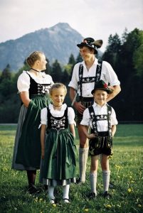 Four family members wearing traditional German costumes - Dirndl and Lederhosen