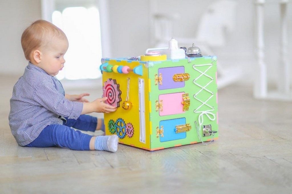 infant baby plaing with toys