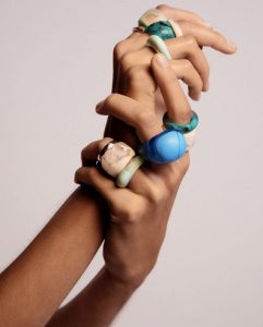 woman showing off hands with beautiful resin rings