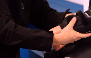 putting on a hockey elbow pad