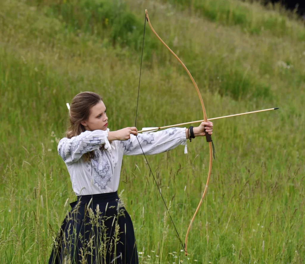 woman with Traditional archery Recurve Bow