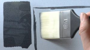 person painting with mottler