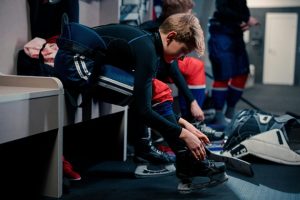 kid putting on his hockey skates